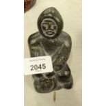 An Inuit carved stone figure of an Eskimo, scratch number 1791 to underside, 11cm high.