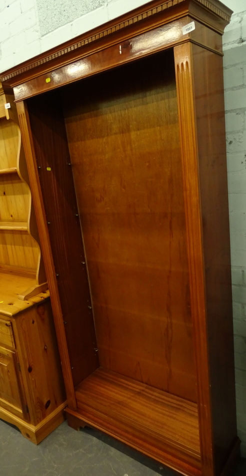 A yew wood freestanding open bookcase with dentil top, on bracket feet, 184cm high, 92cm wide, 184cm