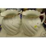 A pair of Limoges porcelain wash jugs, each with wrythen decoration, printed marks to underside