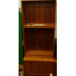 A 1970's G Plan bookcase with open shelves, above a double cupboard, label to the interior, 199cm