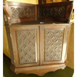 A 19thC walnut corner cabinet, carved with lozenges and roundels with two panelled doors and a