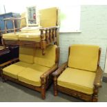 A pair of oak framed two seater sofas and an armchair. (3)The upholstery in this lot does not comply