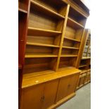 A 20thC oak open bookcase, set with various adjustable shelves, the upper open section raised