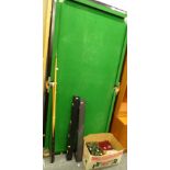 A baize lined quarter slate bed snooker table, 93cm wide, with an assortment of balls, cues etc. (