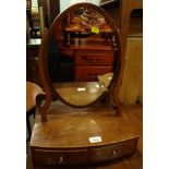 A late 19th/early 20thC mahogany dressing table mirror, the oval plate on shaped supports, the bow