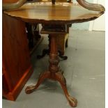 A mahogany occasional table in George III style, the circular top with a pie crust border on a