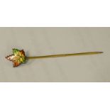 A late 19thC sycamore leaf stick pin, with enamelled leaf top, marked Sterling, on a base metal pin,