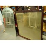 An early 20thC oak overmantel mirror with urn finials and bevel glass, in a moulded frame, 111cm