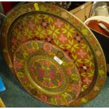 Two similar brass trays, each with coloured enamel type decoration of flowers, leaves, etc.