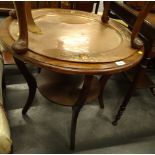An oak two tier occasional table, the top inset with embossed and hammered copper Arts and Crafts