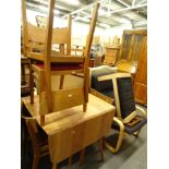 A cantilever chair and foot stool, a lightwood retro drop leaf table and four oak dining chairs,