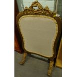 A late 19th/early 20thC gilt gesso fire screen, with blue damask fabric insert to one side, the