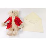 A Steiff musical Mozart plush jointed teddy bear, wearing red jacket, with red label, with