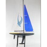 A Hobby King Phantom remote control yacht, yellow and carbon fibre effect hull, 189cm H, 100cm W. (