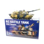 An RC Battle Tank, M1A2 Abrams 1/24 scale, with remote control, boxed.