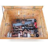A tool box, containing various drill parts and sundry further tools.