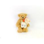 A Hermann Hummel 70 year anniversary plush jointed teddy bear, with red bow and paperwork, 34cm