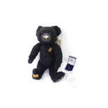 A Merrythought Diamond Anniversary 1930-2005 black plush jointed teddy bear, with label and