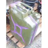 A military jerry can, dated 1987, green with purple over painting.