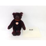 A Steiff limited edition teddy bear, in dark red, number 881/2009, with growl action and brown