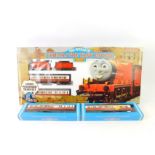A Hornby OO gauge Thomas The Tank Engine set, comprising James The Red Engine, No 5., two coaches,