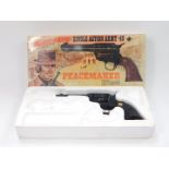 A cowboy toy model of a Peacemaker 1873 Model .45 revolver, blank firing, boxed.
