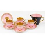 An early 20thC Royal Worcester cabinet cup and saucer set, on pink ground with a white and gilt