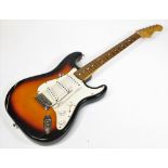A Fender Stratocaster model electric guitar, made in Mexico, in two colour sunburst finish, having