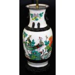 A Japanese pottery lamp vase, of shouldered circular form, polychrome decorated with exotic bird and