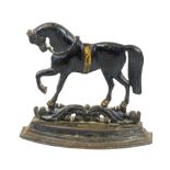 A 20thC cast iron door stop, in the form of a horse, on a stepped base, with pierced scroll stand,