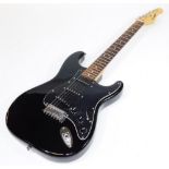 A Westfield Stratocaster type guitar, having black finish with three single coil pickups, rosewood