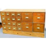 A set of early 20thC pine and oak library card drawers, of rectangular form, with two banks of two