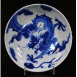 A Chinese porcelain blue and white saucer dish, of circular form decorated with a four clawed dragon