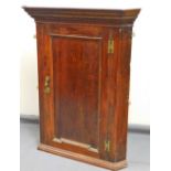 An 18thC oak hanging corner cupboard, with moulded panel door, and a fitted interior with a