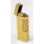 A 20thC Dunhill gold plated pocket lighter, of rectangular form with shaped body, spring loaded lid,