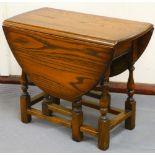 A small oak drop leaf gateleg table, on baluster supports terminating in block feet, when closed