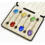 A set of six silver and enamel bean spoons, to include dark blue, light blue, etc. with bean tops,