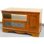 A late 20thC oak Old Charm style television cabinet, of octagonal form with linen fold and glass