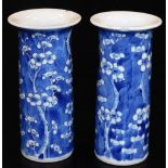 A pair of late 19thC Chinese porcelain prunus vases, each of trumpet form in blue and white, four