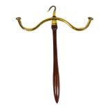 A brass topped wig stand, on turned stem with hook top, 51cm high.