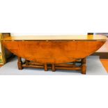 A George III style oak gateleg wake table, with curved top, double gateleg action, turned legs and