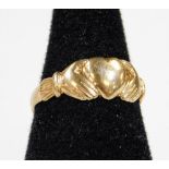 A 9ct gold ring with heart and hand emblem, size L-M, 2g.