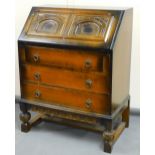 A 20thC oak finish bureau, with panelled fall above three drawers with ring handles and