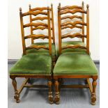 A set of four leather ladderback dining chairs, each with overstuffed seats in green material on