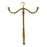 A brass topped wig stand, on turned stem with hook top, 51cm high.