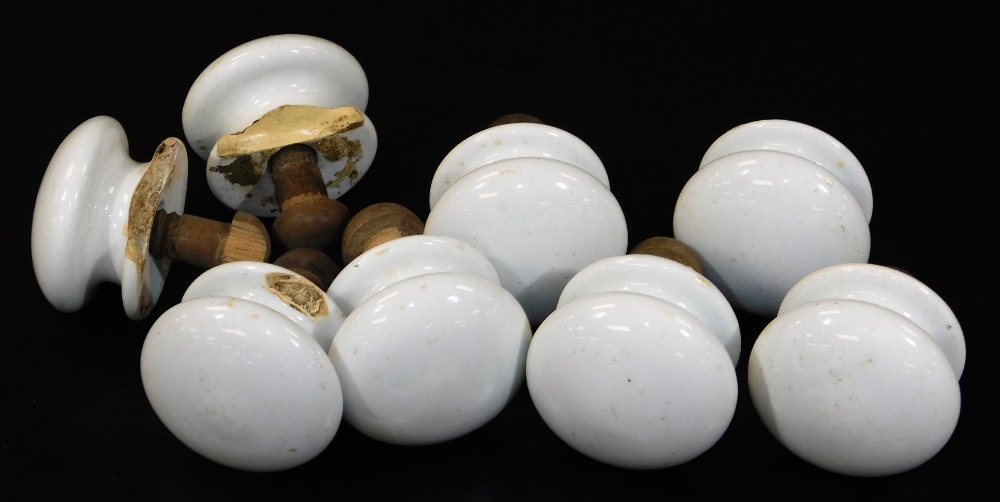 Various 19thC pot knob handles, painted white, many with wooden backs, 6cm diameter. (a quantity)