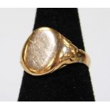 A signet ring, with plain head and textured shank, marked 9ct, size N, 5.3g.