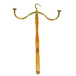 A brass topped wig stand, on turned stem with hook top, 51cm high.