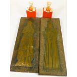 A pair of rectangular brass rubbing plaques, each raised with metal figures in medieval dress and