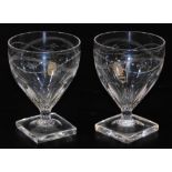 A pair of 19thC glass rummers, each with shaped gadrooned bowls, partially painted with garlands, on